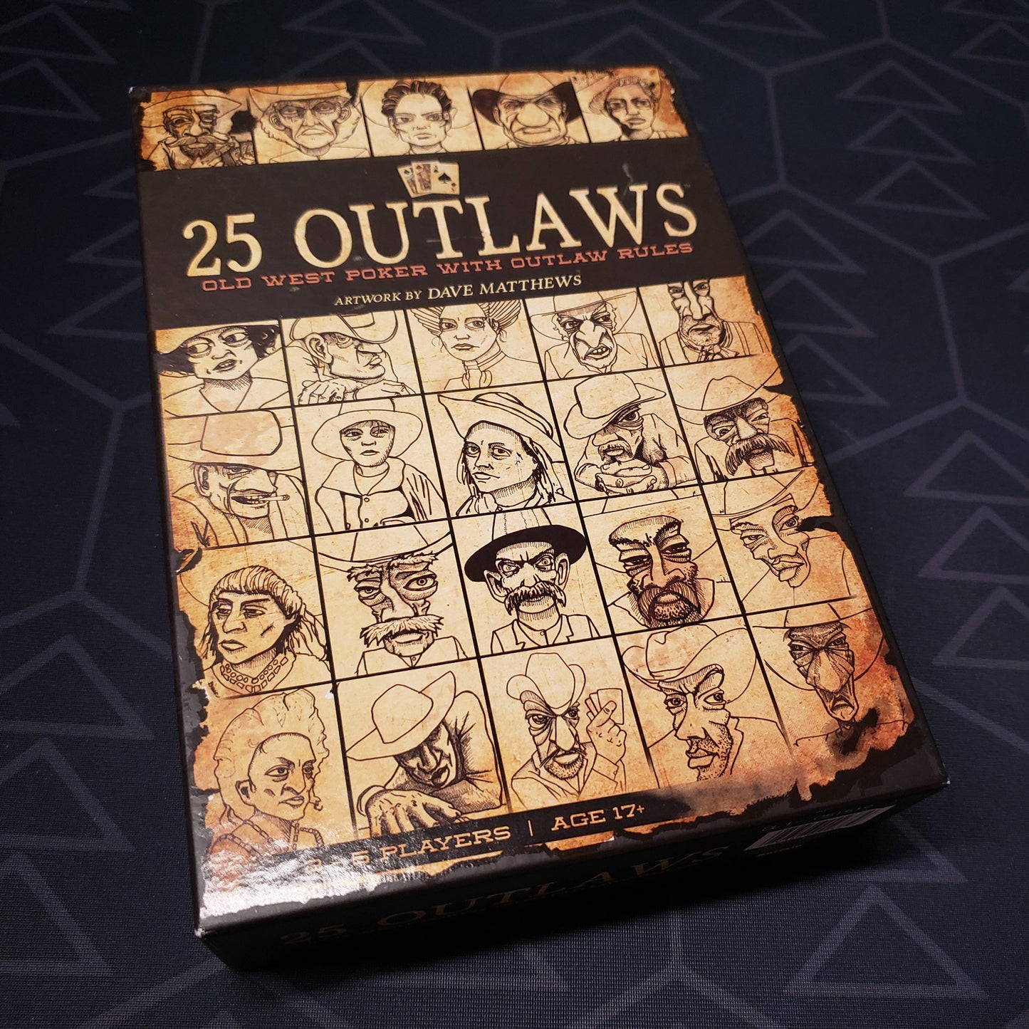 Image shows the front cover of the box of the 25 Outlaws card game