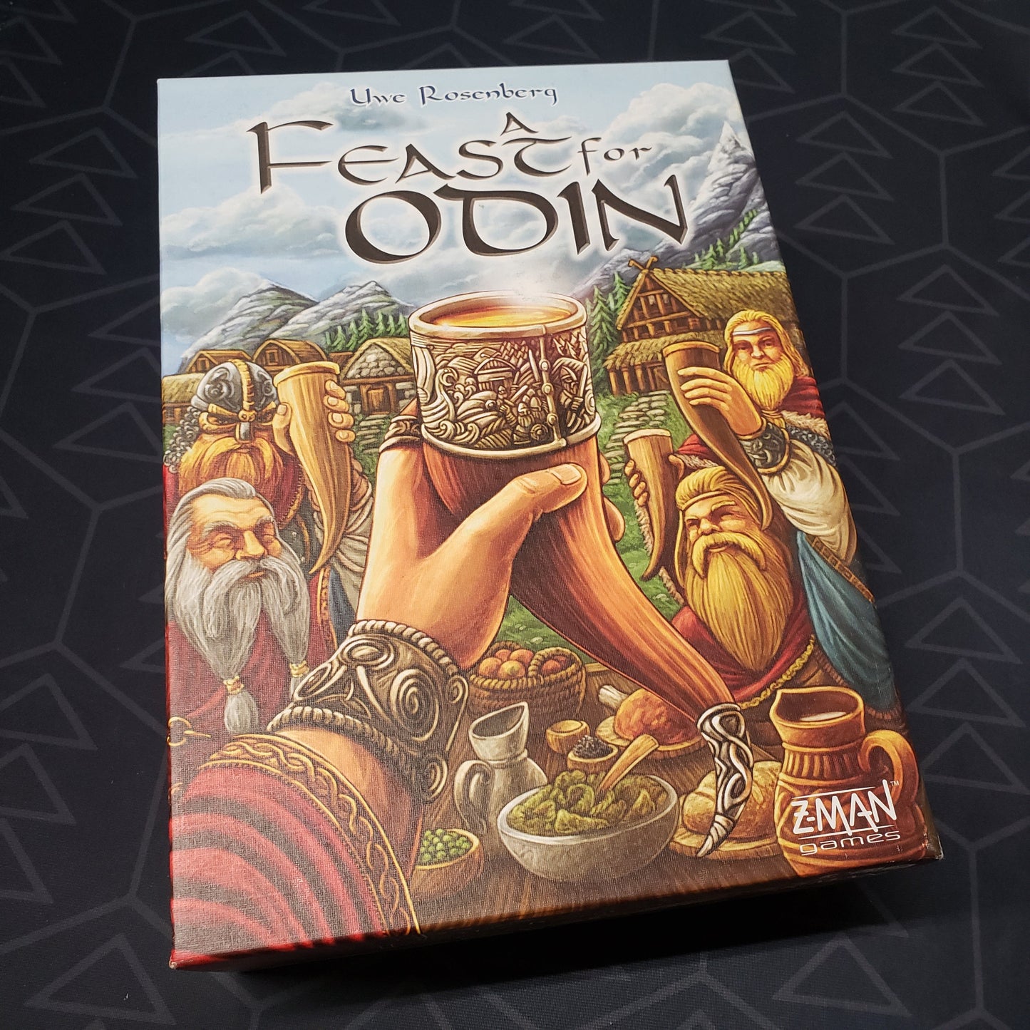 Image shows the front cover of the box for the board game A Feast for Odin