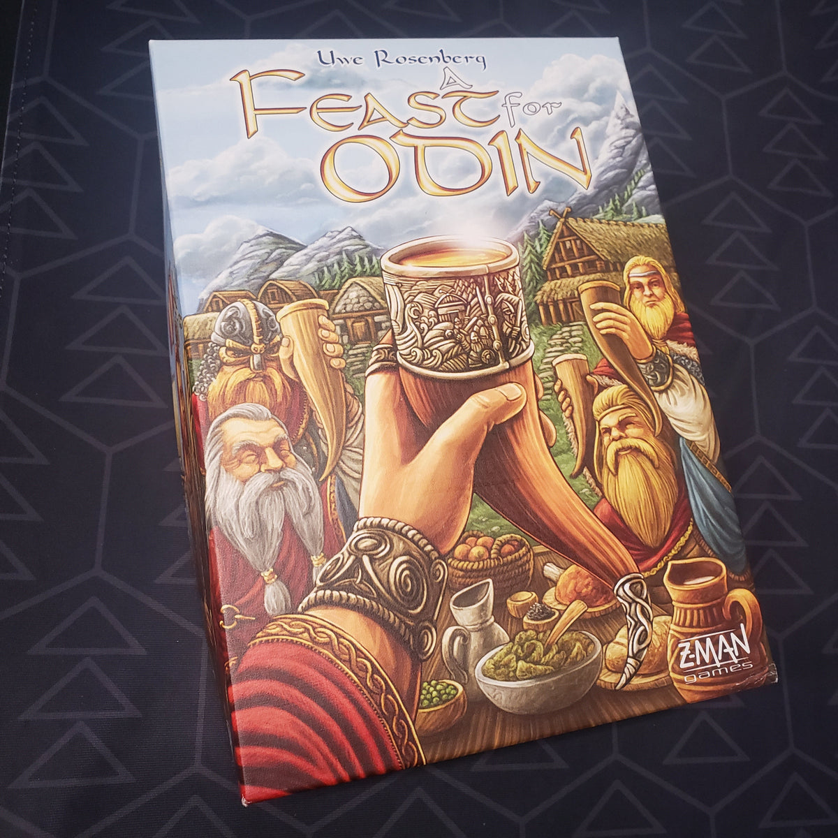 Image shows the front cover of the box for the board game A Feast for Odin