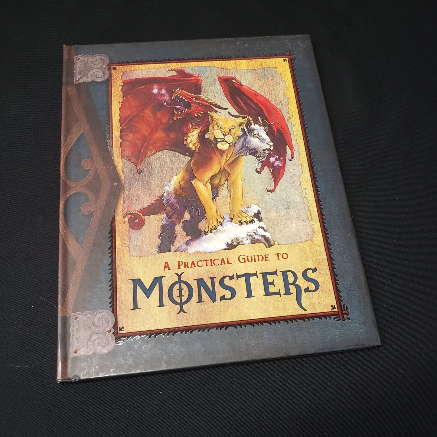 Image shows the front cover of the Practical Guide to Monsters roleplaying game book