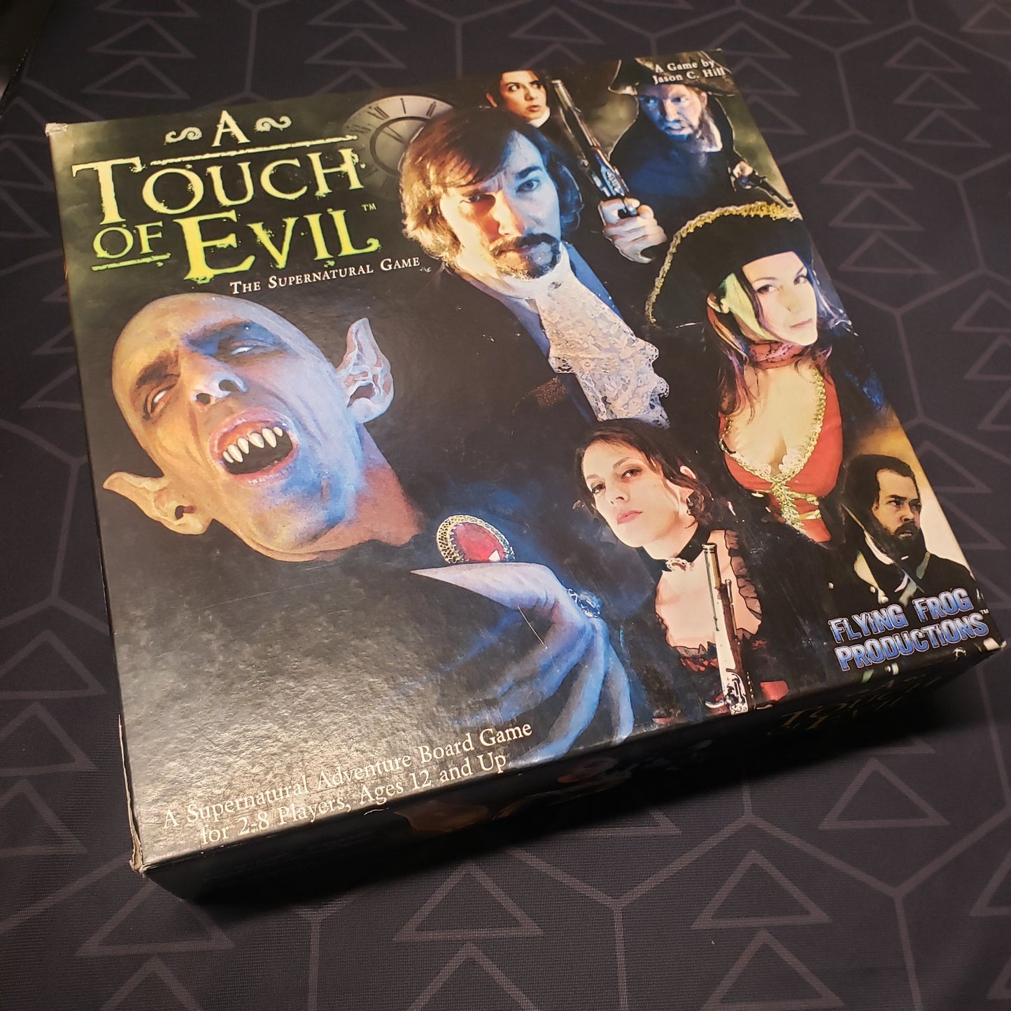 Image shows the front cover of the box of the board game A Touch of Evil