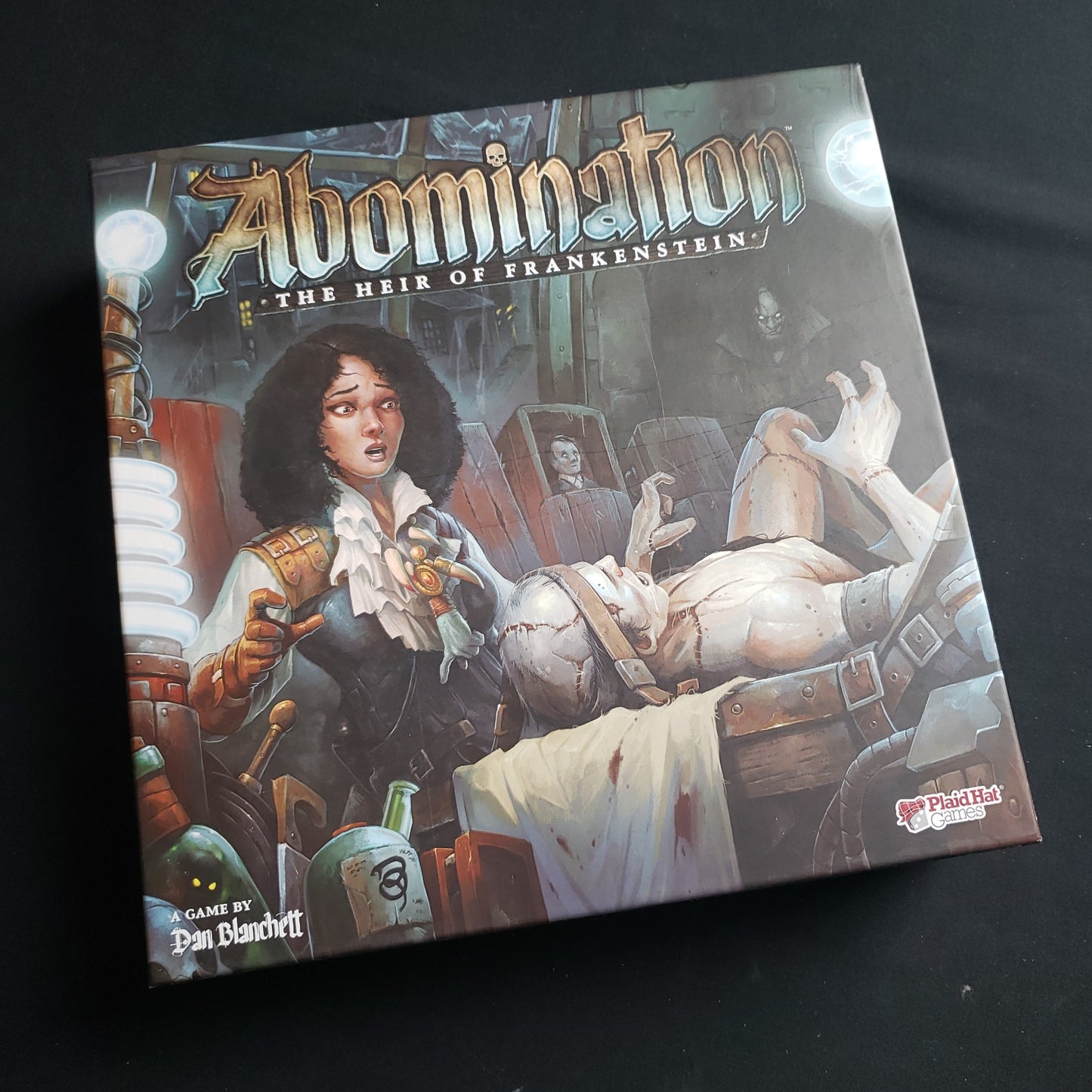 Image shows the front cover of the box of the Abomination: The Heir of Frankenstein board game