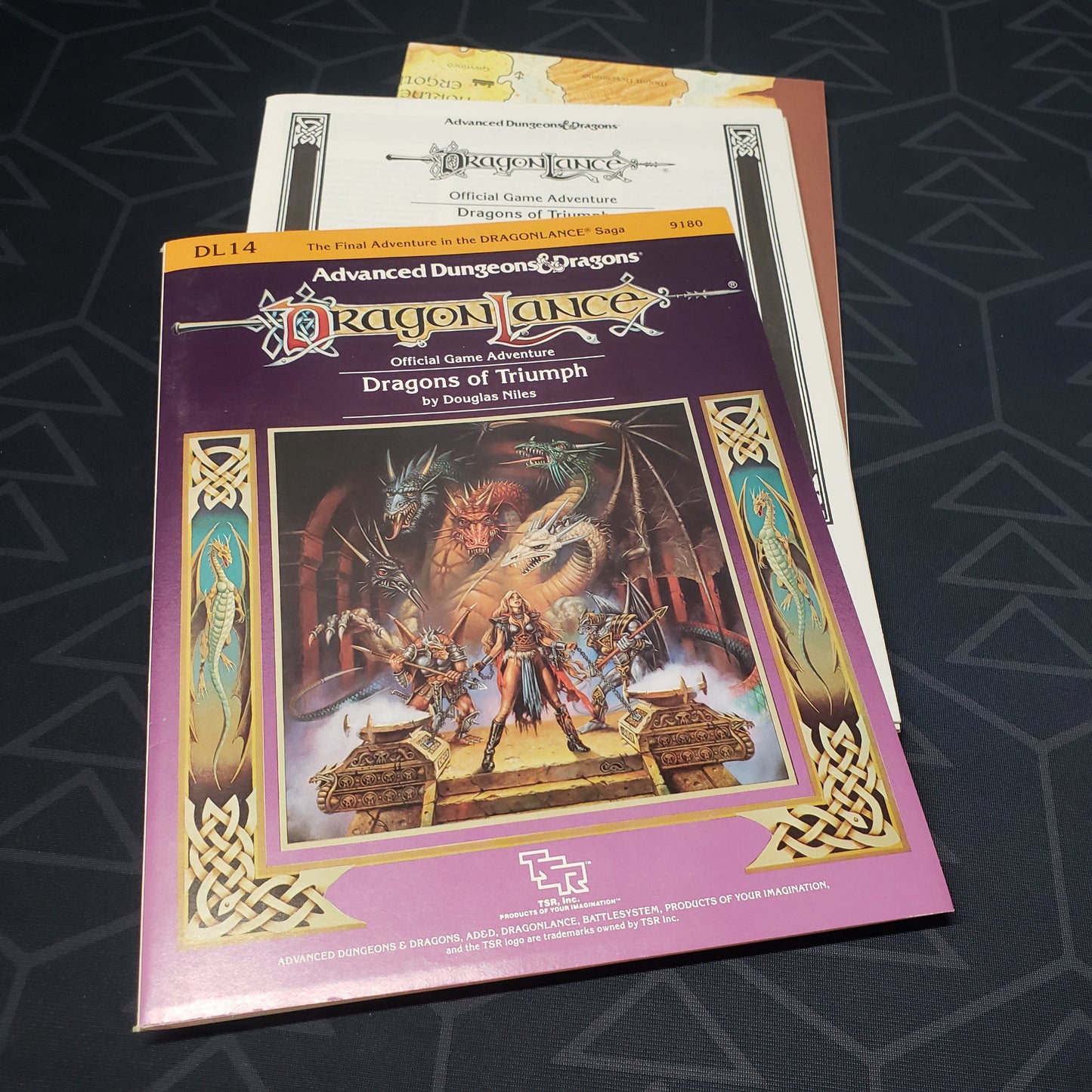 Image shows the front cover of the folio for the Dragonlance: Dragons of Triumphr adventure module for the roleplaying game Advanced Dungeons & Dragons: First Edition, with the booklet and map inserts fanned out