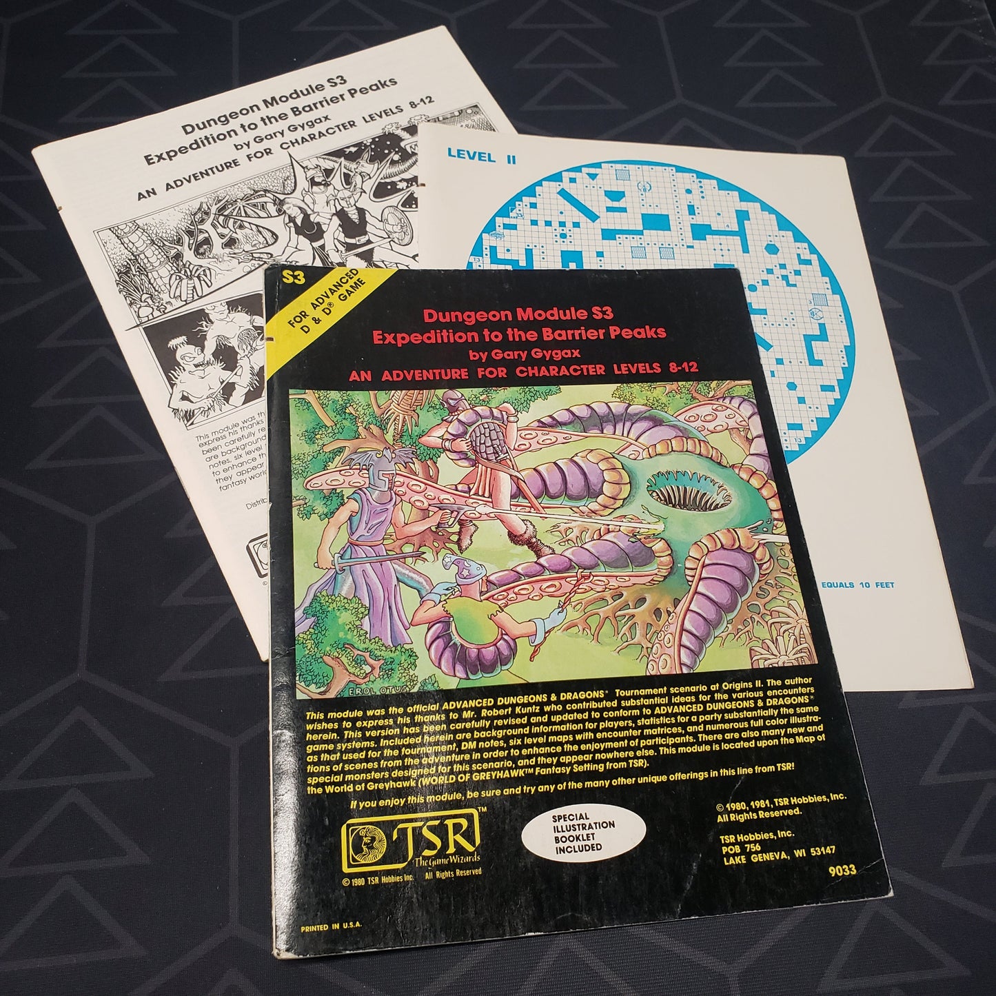 Image shows the front cover of the folio for the Expedition to the Barrier Peaks adventure module for the roleplaying game Advanced Dungeons & Dragons 1E with the booklet & map insert fanned out