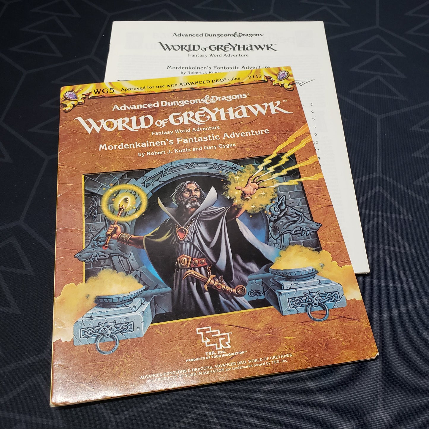 Image shows the front cover of the folio for the Mordenkainen's Fantastic Adventure module for the roleplaying game Advanced Dungeons & Dragons: First Edition, with the booklet fanned out