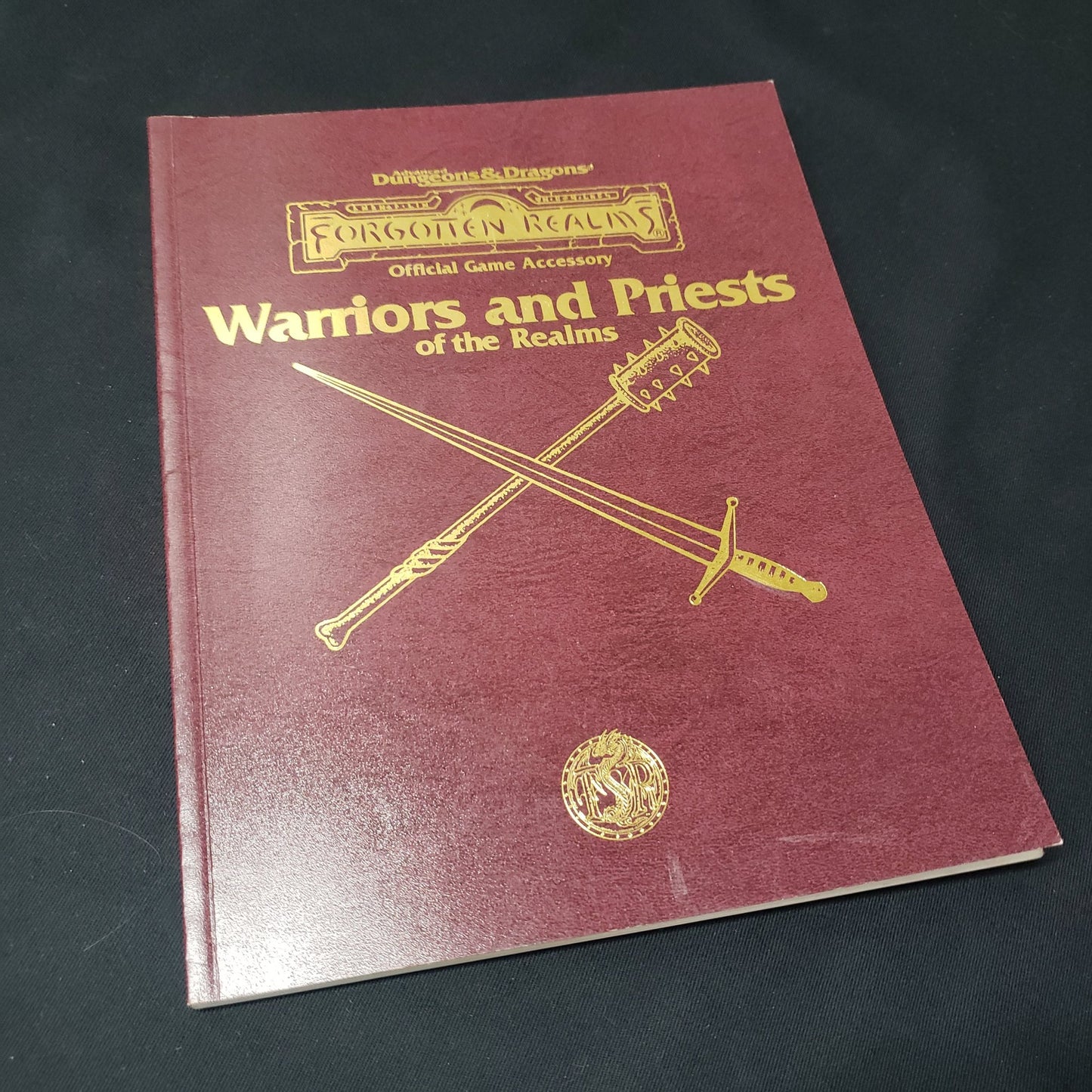 Image shows the front cover of the Warriors and Priest of the Realms book for the roleplaying game Advanced Dungeons & Dragons: Second Edition