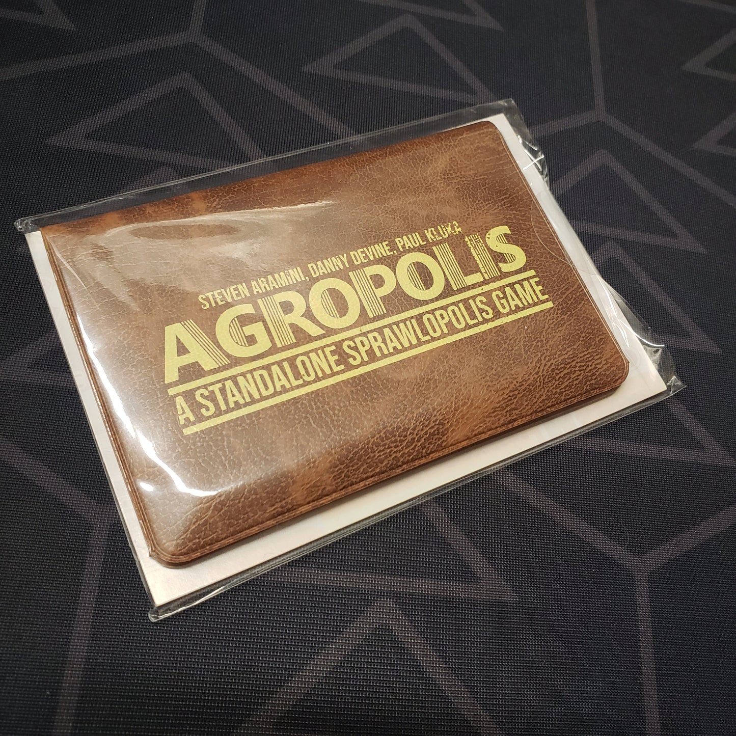 Image shows the front of the card wallet for the Agropolis card game