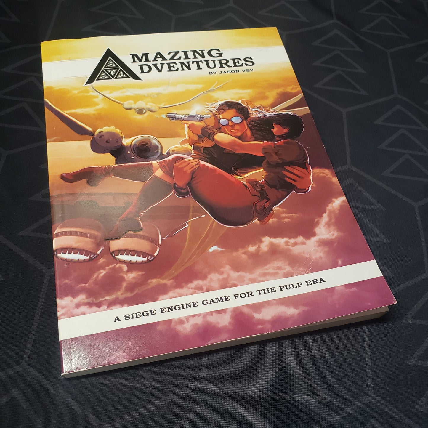 Image shows the front cover of the core rulebook for the roleplaying game Amazing Adventures
