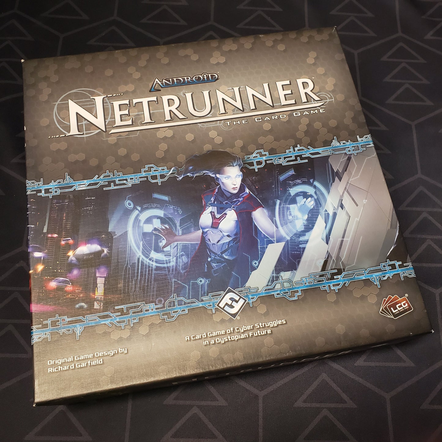 Image shows the front cover of the box of the Android Netrunner card game