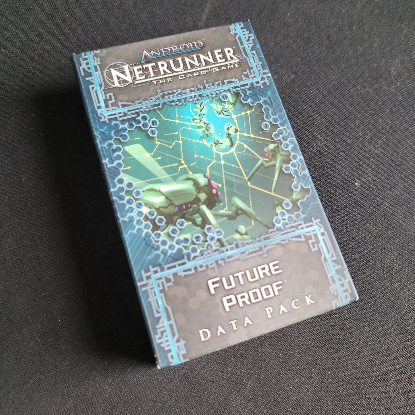 Image shows the front of the package for the Future Proof Data Pack for the Android: Netrunner card game