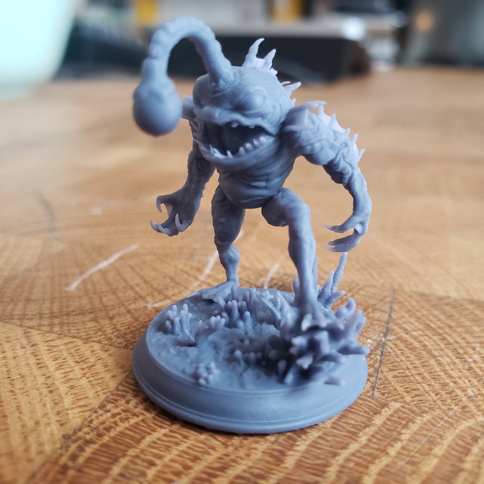 Image shows an example of a 3D printed fishfolk horror gaming miniature printed in-house at All Systems Go