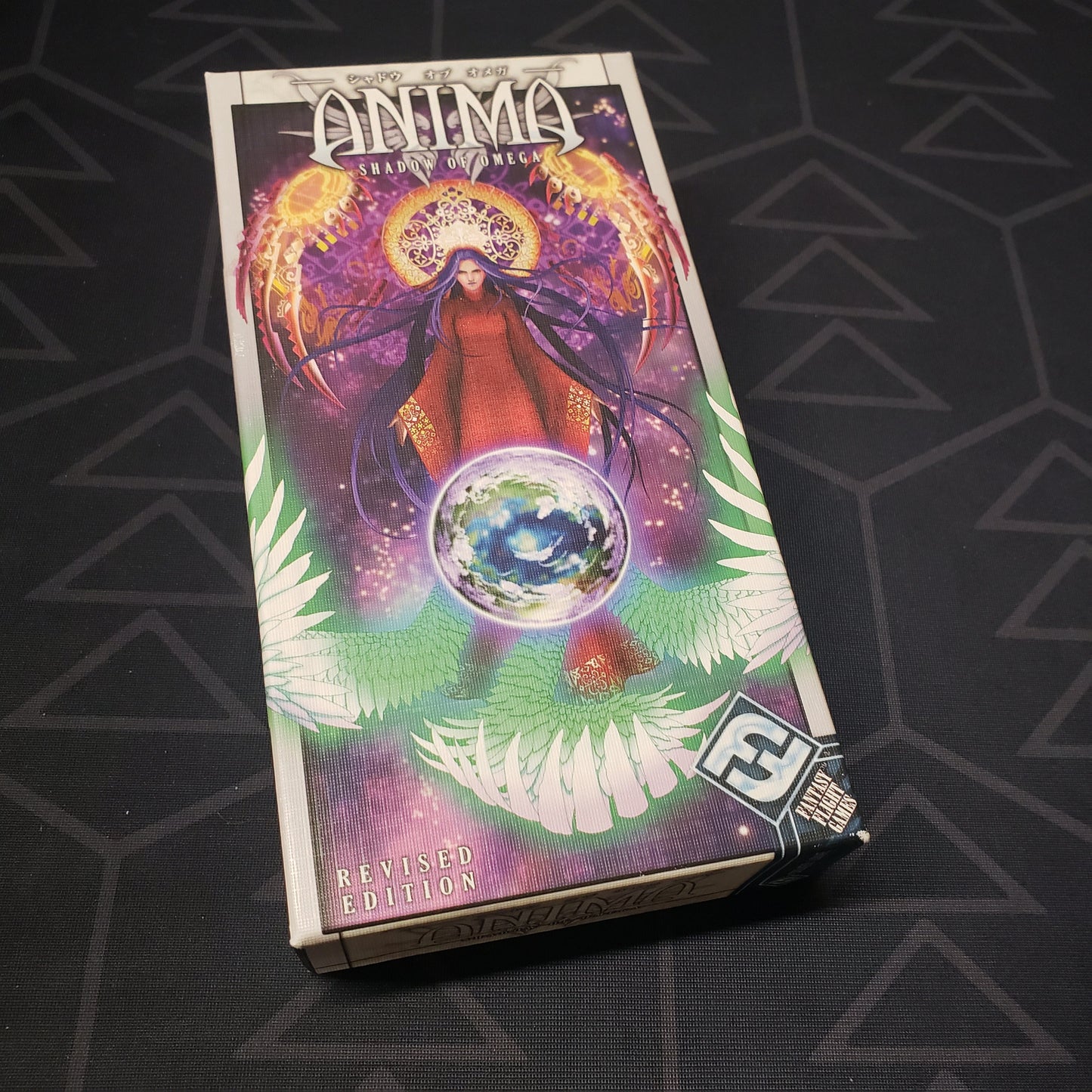 Image shows the front cover of the box of the Anima: Shadow of Omega card game