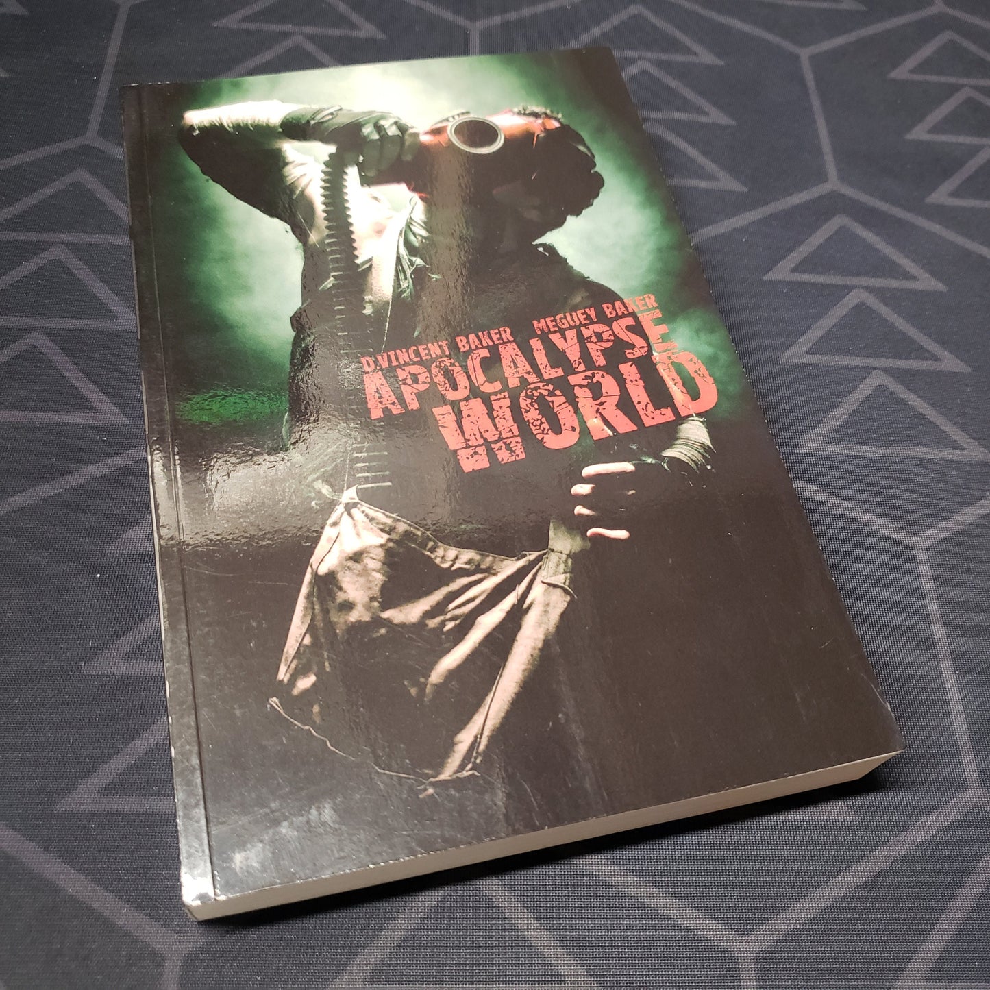 Image shows the front cover of the core rulebook for the roleplaying game Apocalypse World