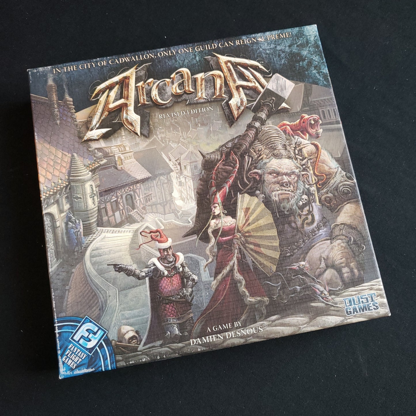 Image shows the front cover of the box of the Arcana card game
