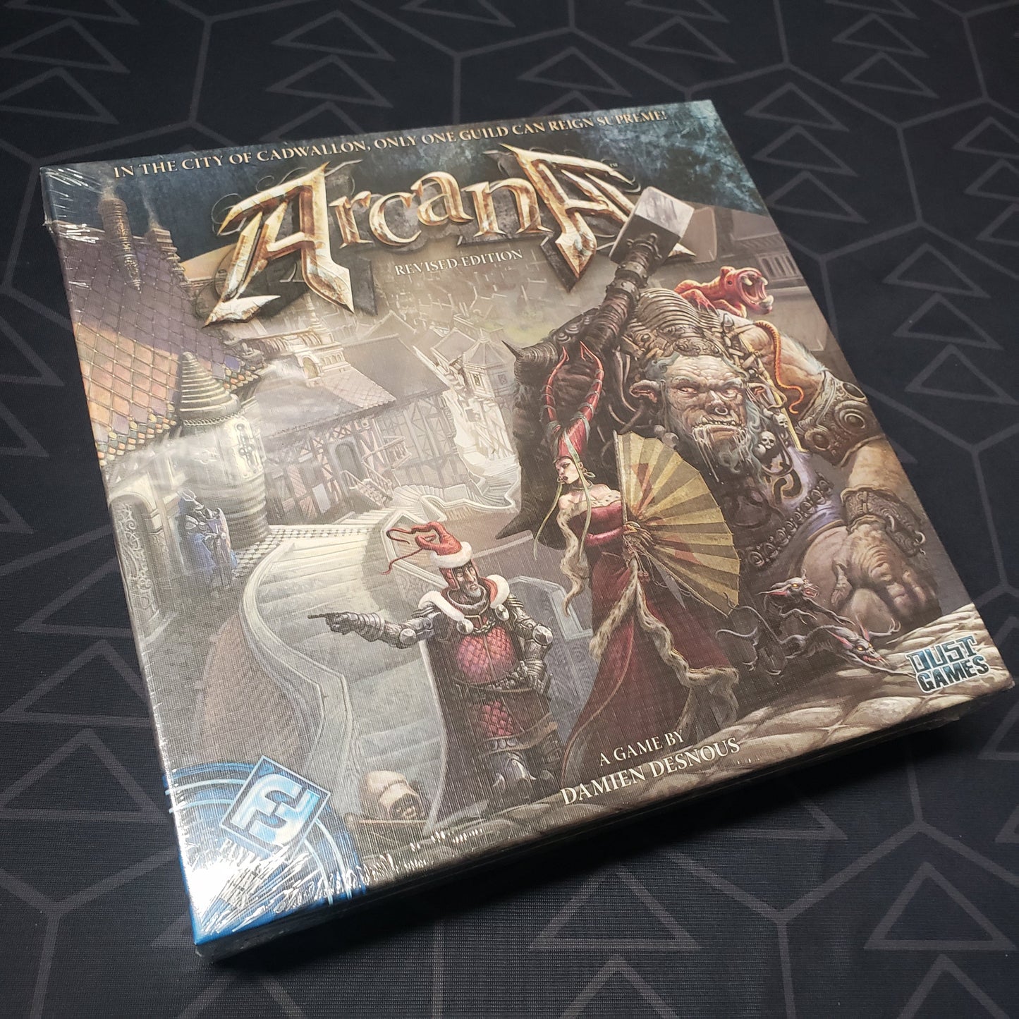 Image shows the front cover of the box of the Arcana card game