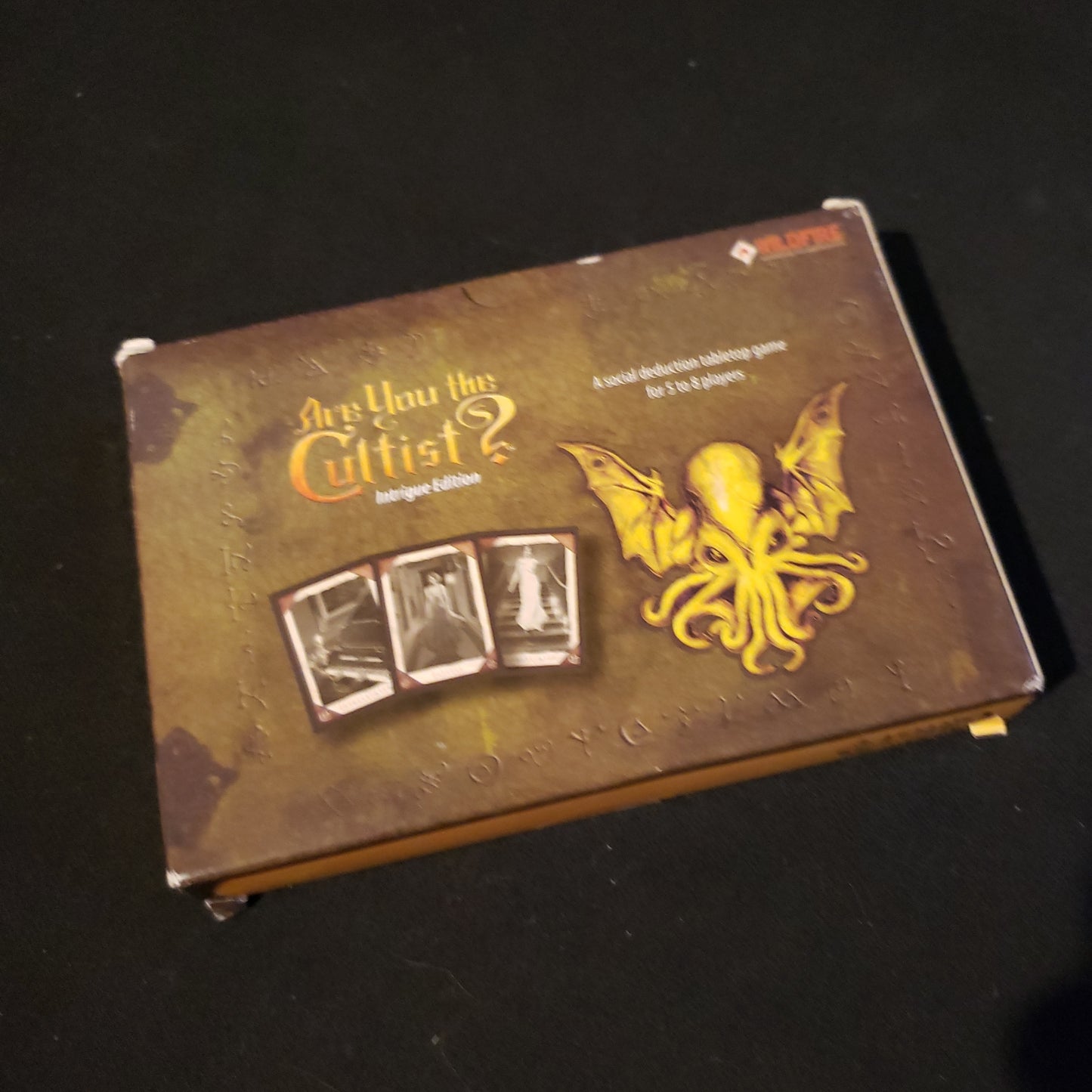 Image shows the front cover of the box of the Are You The Cultist?: Intrigue Edition card game