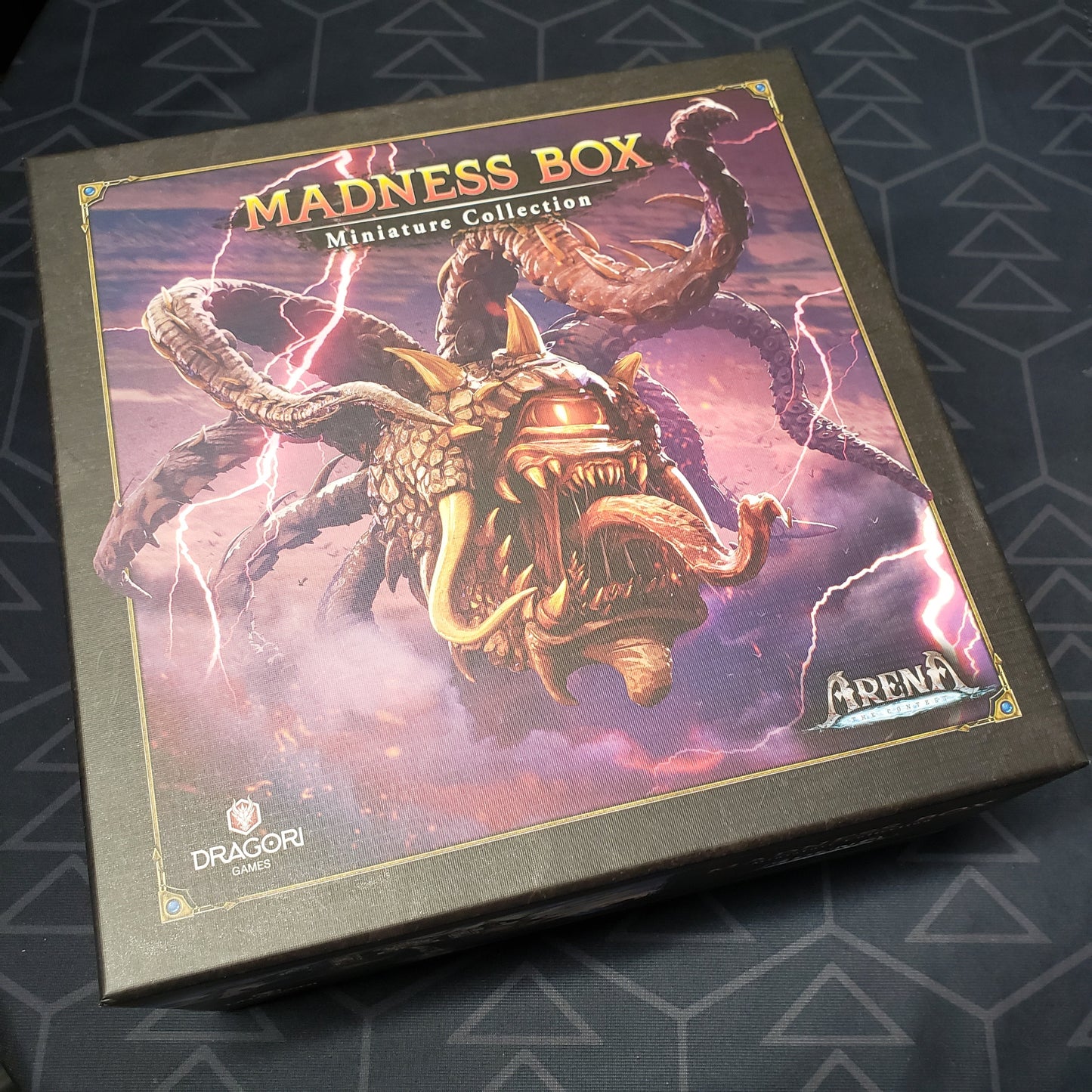 Image shows the front of the box for the Madness Box Miniature Collection for the board game Arena: The Contest