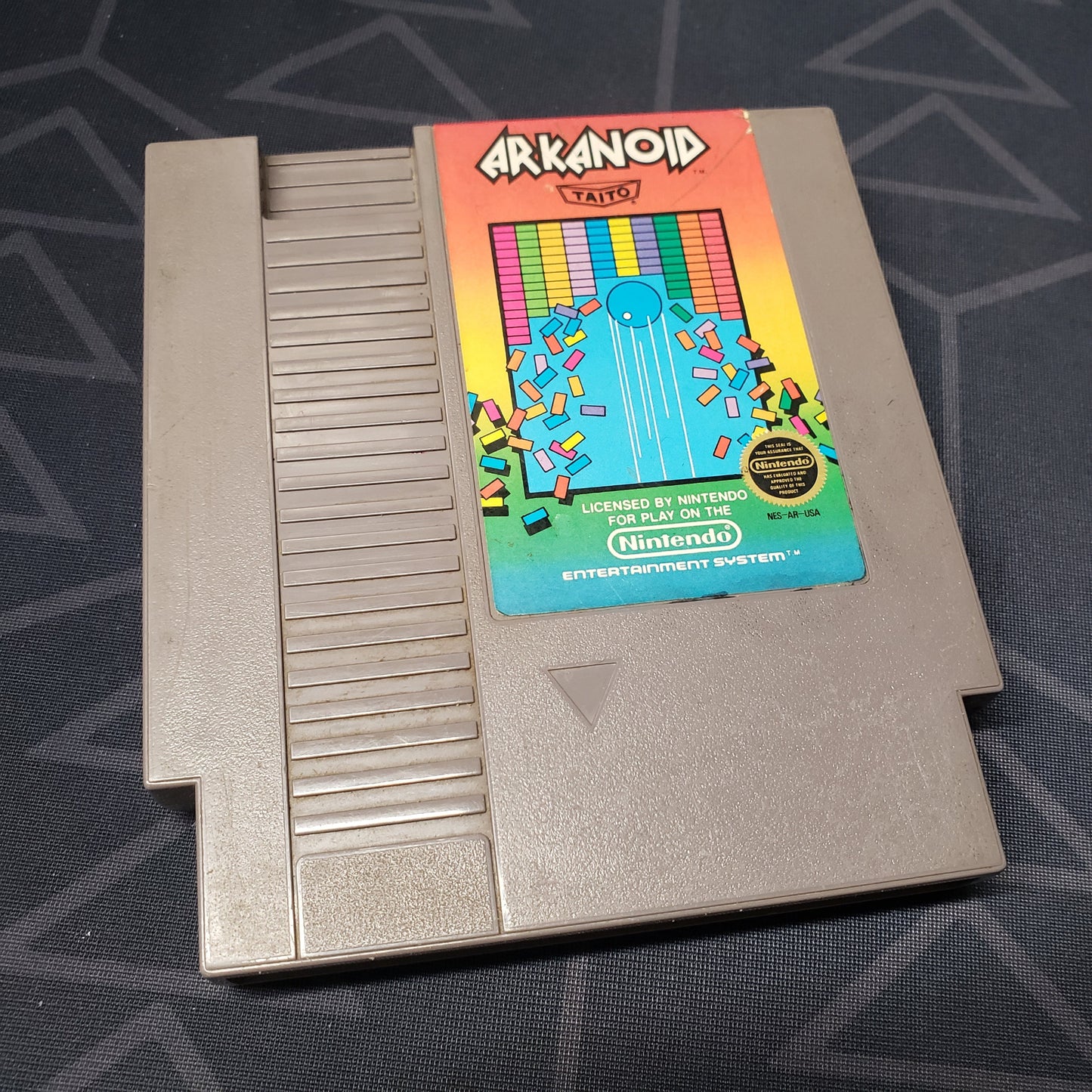 Image shows the front of the cartridge for the video game Arkanoid for the Nintendo Entertainment System