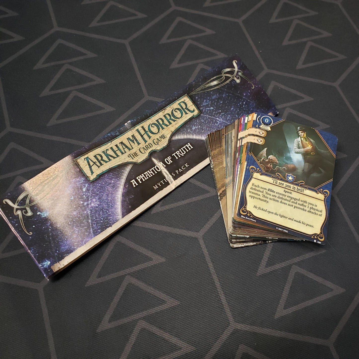 Image shows the instructions and fanned-out cards for the Phantom of Truth Mythos Pack expansion for Arkham Horror: The Card Game