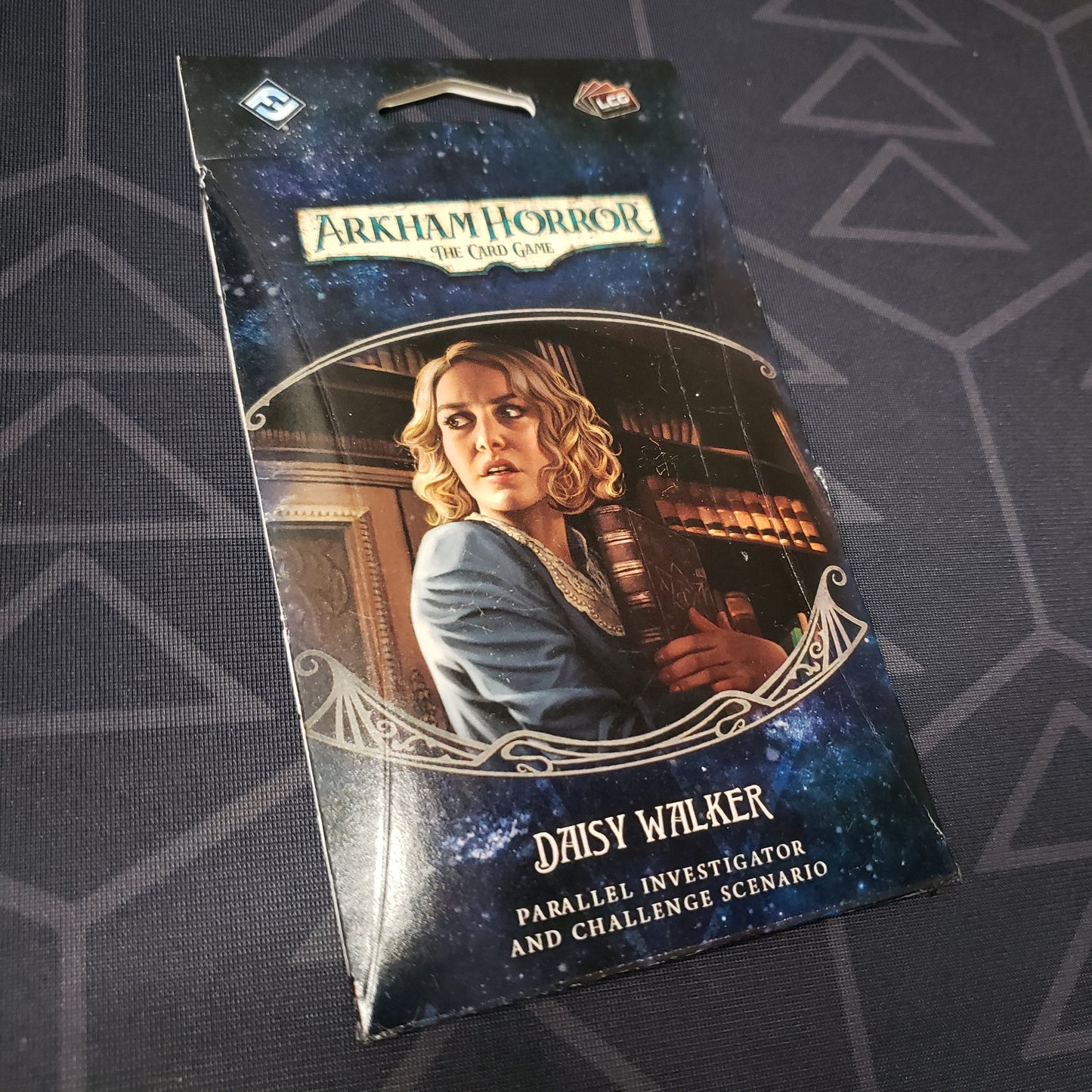 Image shows the front of the packaging of the Daisy Walker Parallel Investigator & Challenged Scenario expansion for Arkham Horror: The Card Game