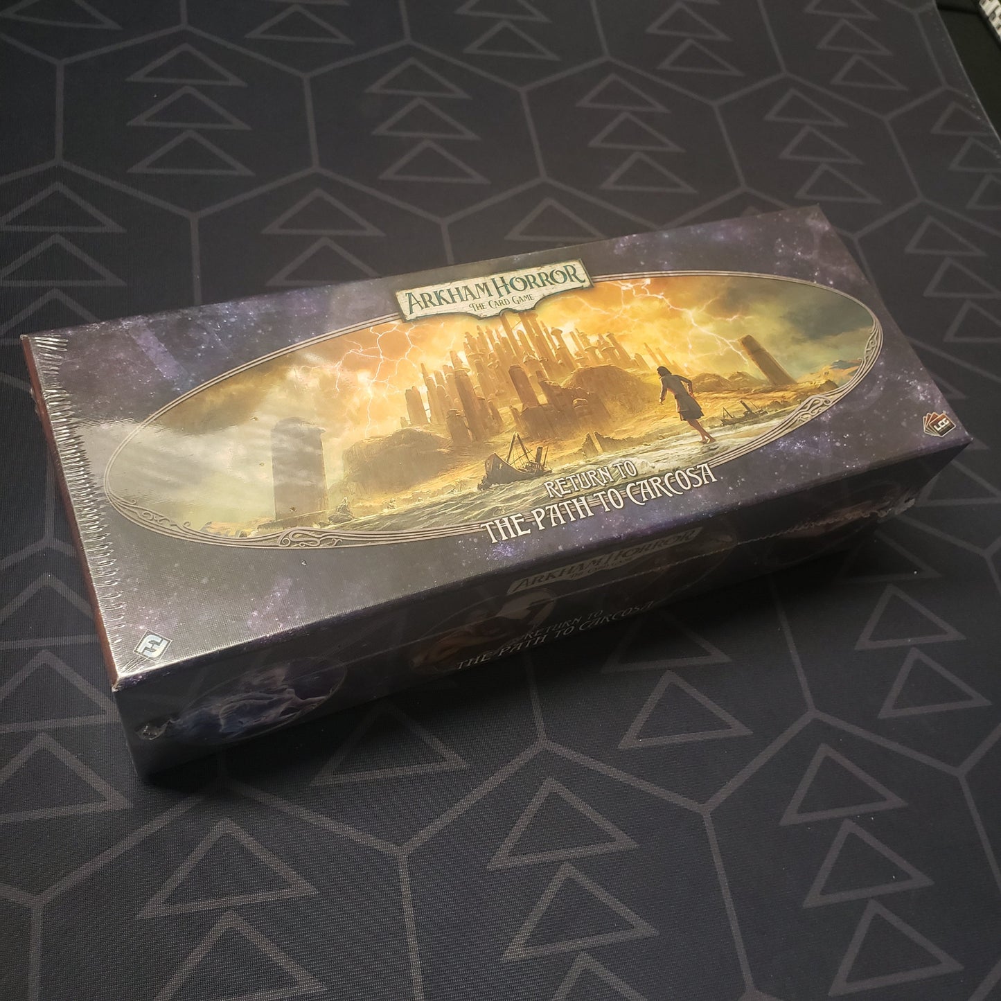 Image shows the front cover of the box of the Return to the Path to Carcosa expansion for the Arkham Horror card game