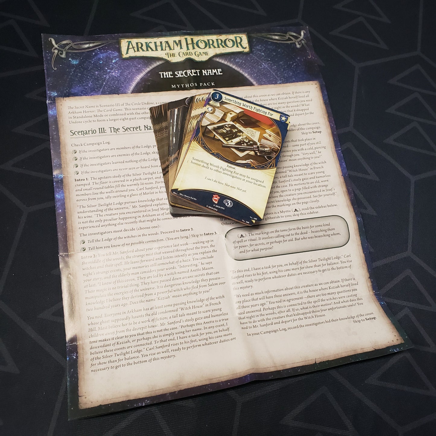 Image shows the cards & instruction sheet for the Secret Name Mythos pack for the card game Arkham Horror