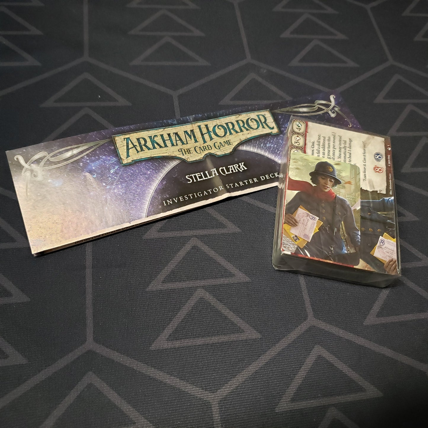 Image shows the shrinkwrapped cards & instructions for the Stella Clark Investigator Starter Deck from the Arkham Horror Card Game