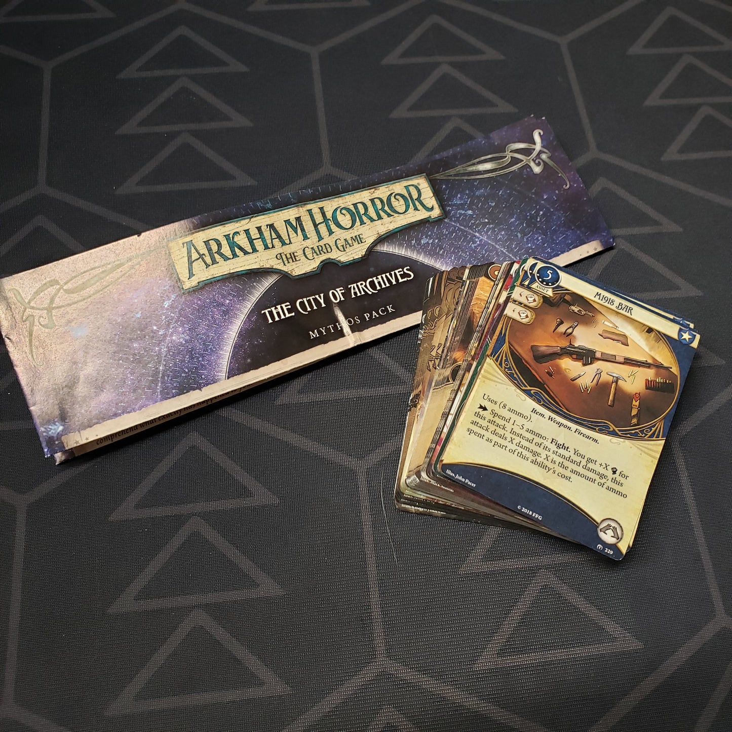 Image shows the instructions & cards for the City of Archives Mythos Pack expansion for Arkham Horror: The Card Game