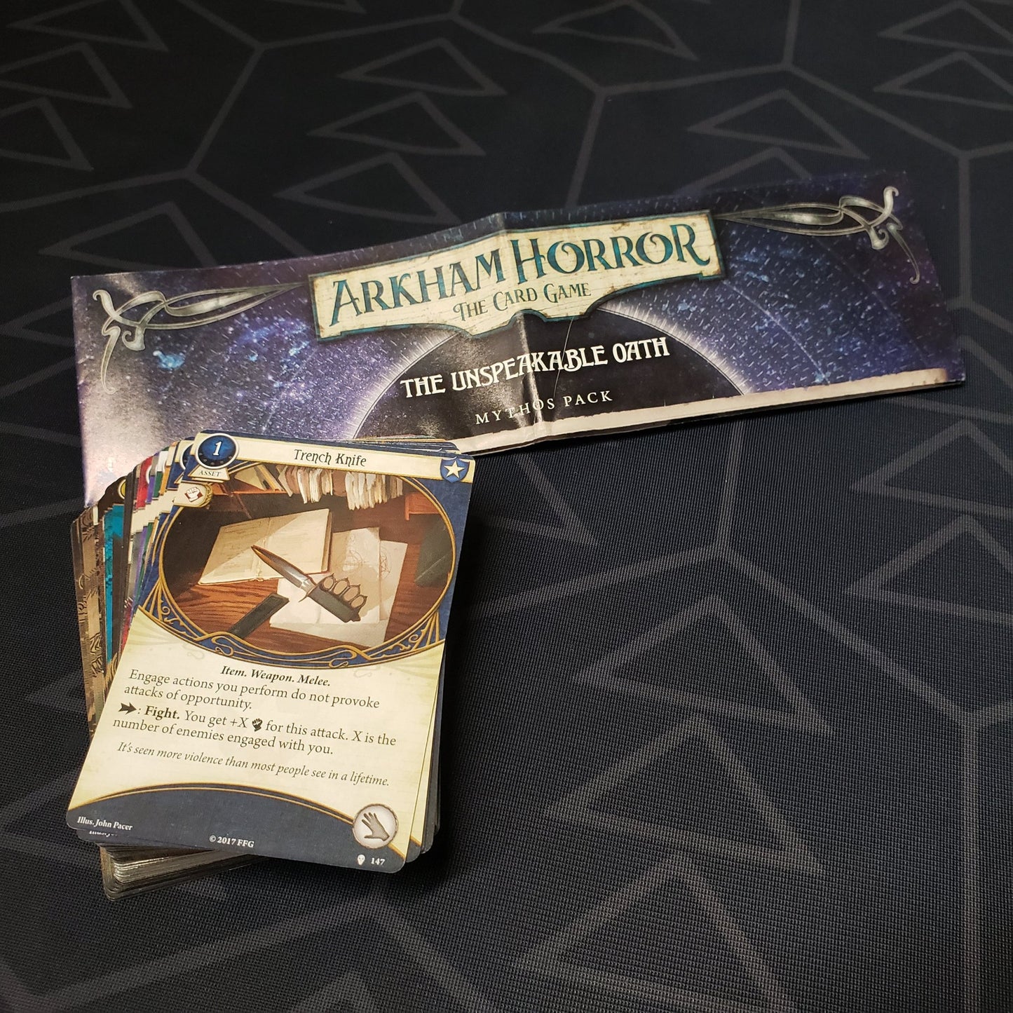 Image shows the instructions and cards for the Unspeakable Oath Mythos Pack expansion for Arkham Horror: The Card Game