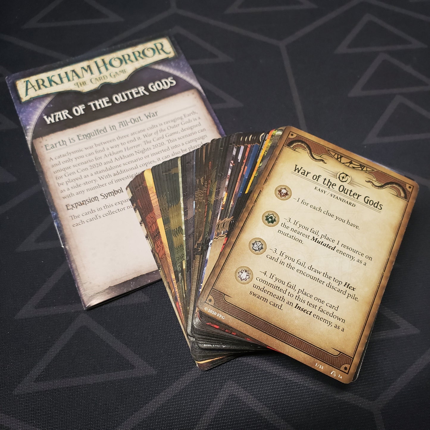 Image shows the cards & instruction sheet for the War of the Outer Gods Scenario pack for the card game Arkham Horror
