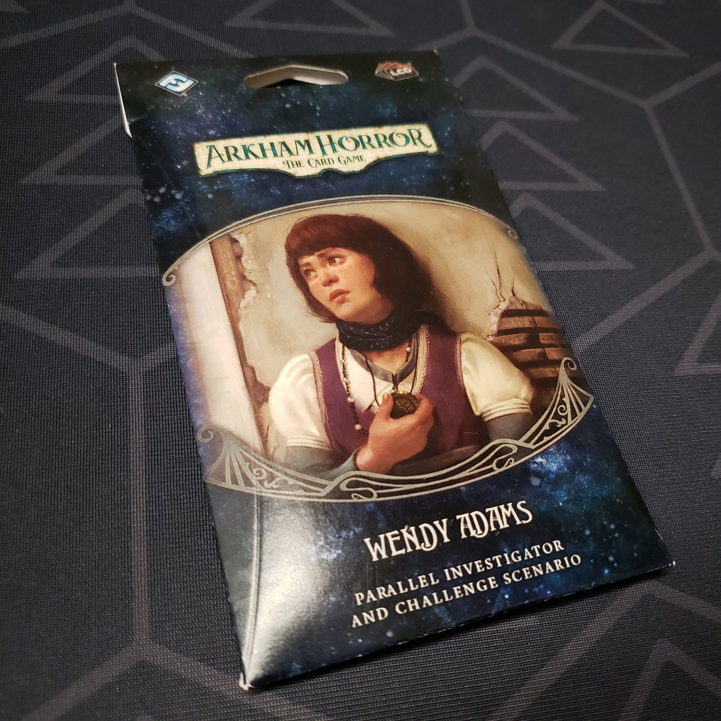 Image shows the front of the packaging of the Wendy Adams Parallel Investigator & Challenged Scenario expansion for Arkham Horror: The Card Game