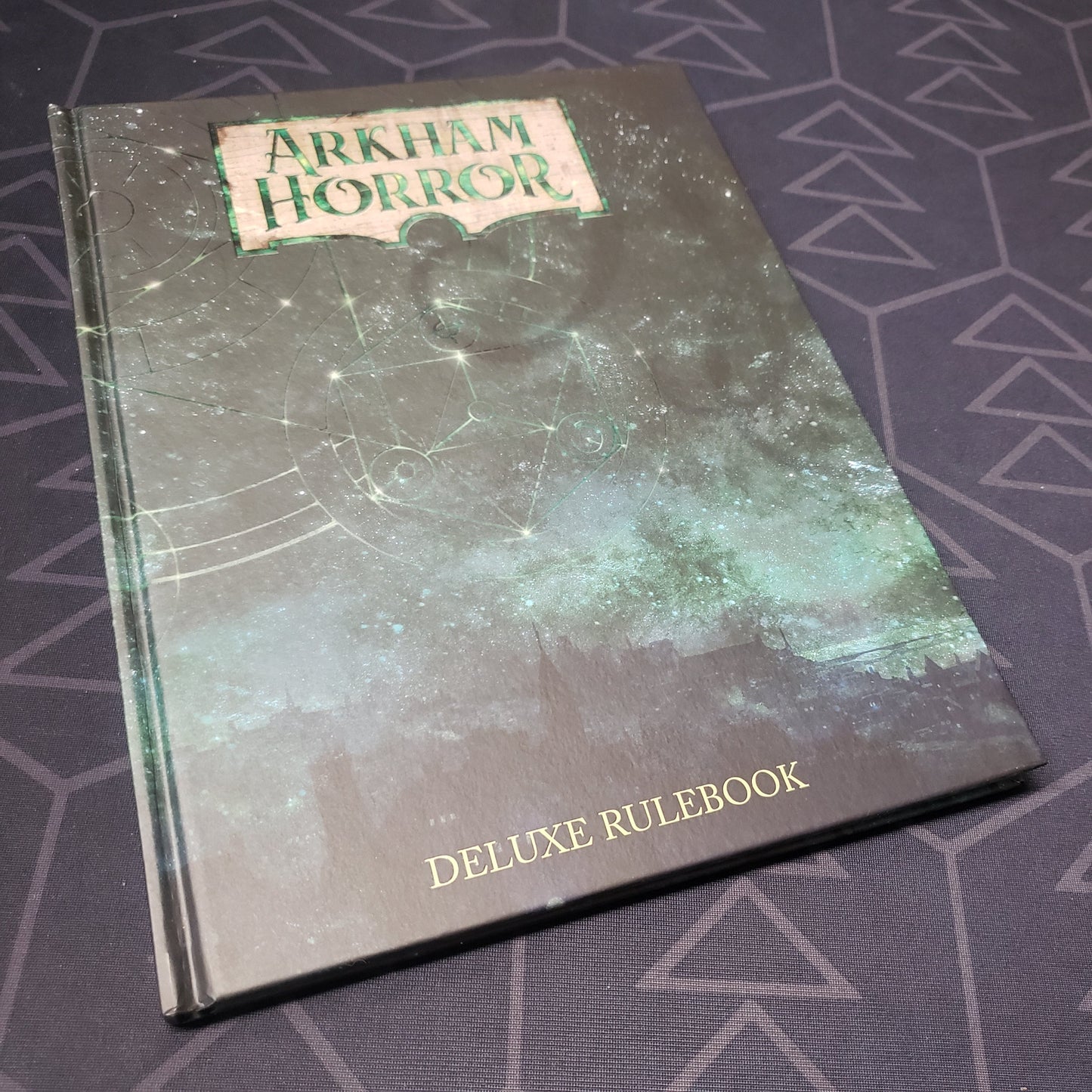 Image shows the front cover of the Arkham Horror: Third Edition Deluxe Rulebook gaming book