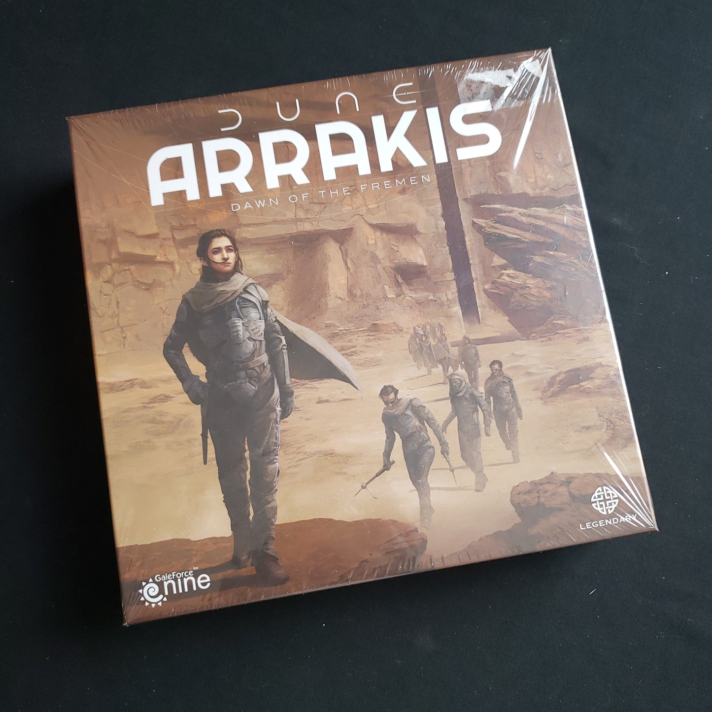 Image shows the front cover of the box of the Arrakis: Dawn of the Fremen board game
