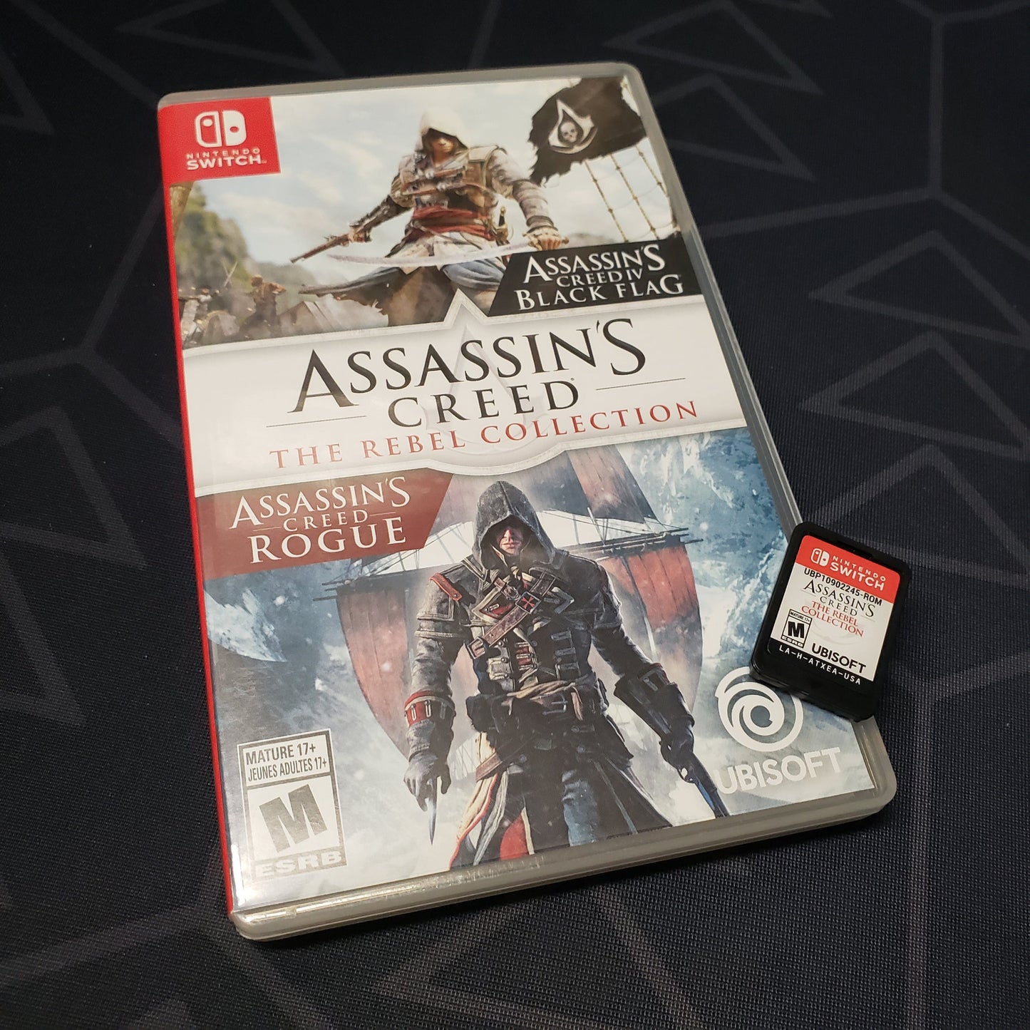 Image shows the case and cartridge for the video game Assassin's Creed: The Rebel Collection for Nintendo Switch