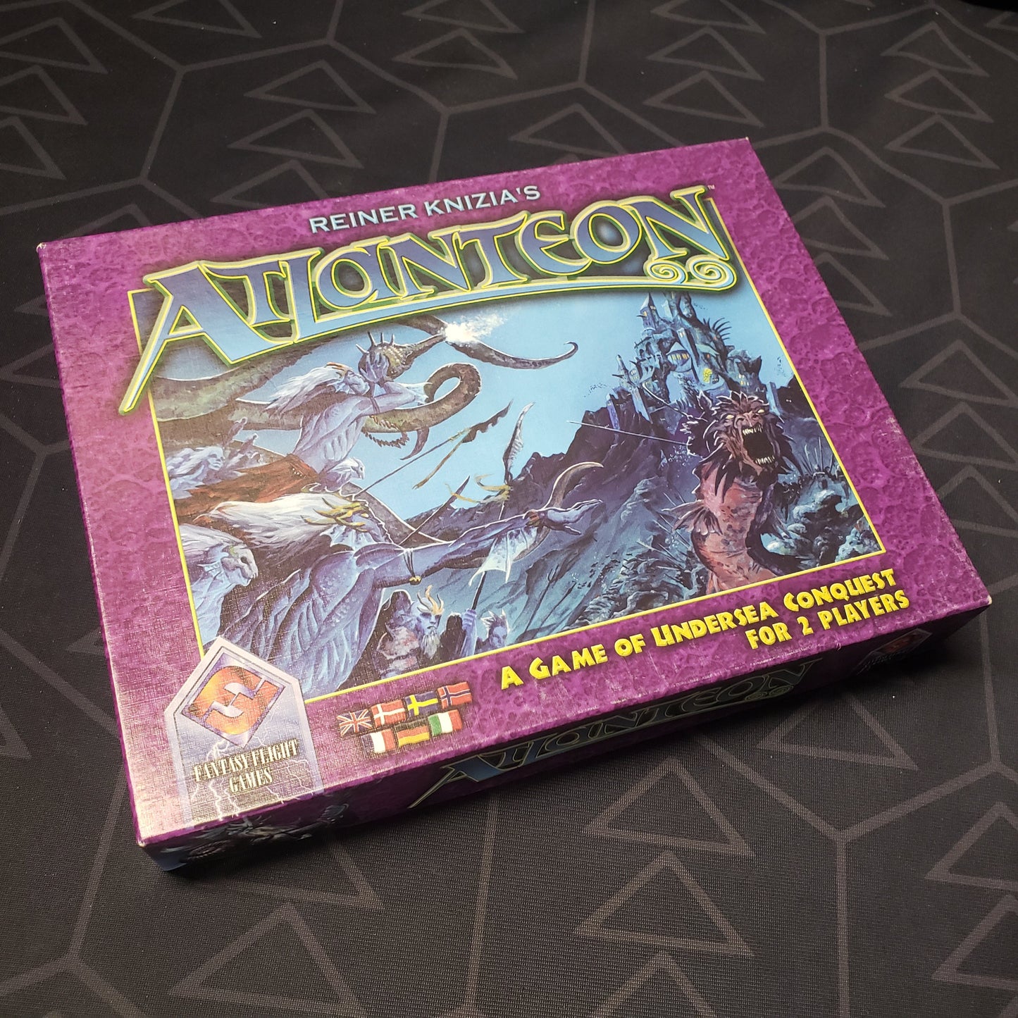Image shows the front cover of the box of the Atlanteon board game