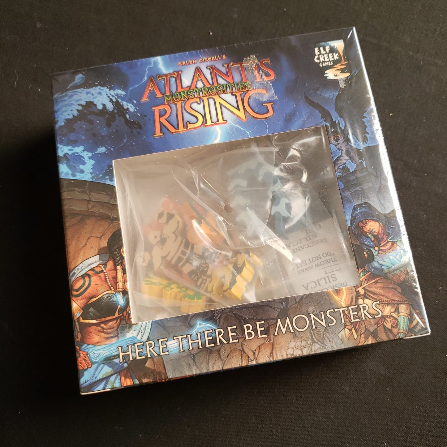 Image shows the front of the box for the Monstrosities: Here There Be Monsters Promo Expansion for the Atlantis Rising board game