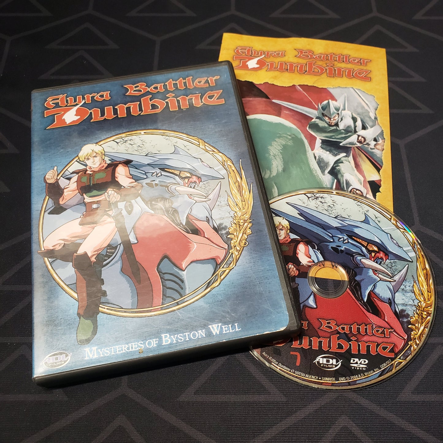 Image shows the case, insert & disc for the Volume 7: Mysteries of Byson Well episode disc of the anime TV series Aura Battler Dunbine on DVD