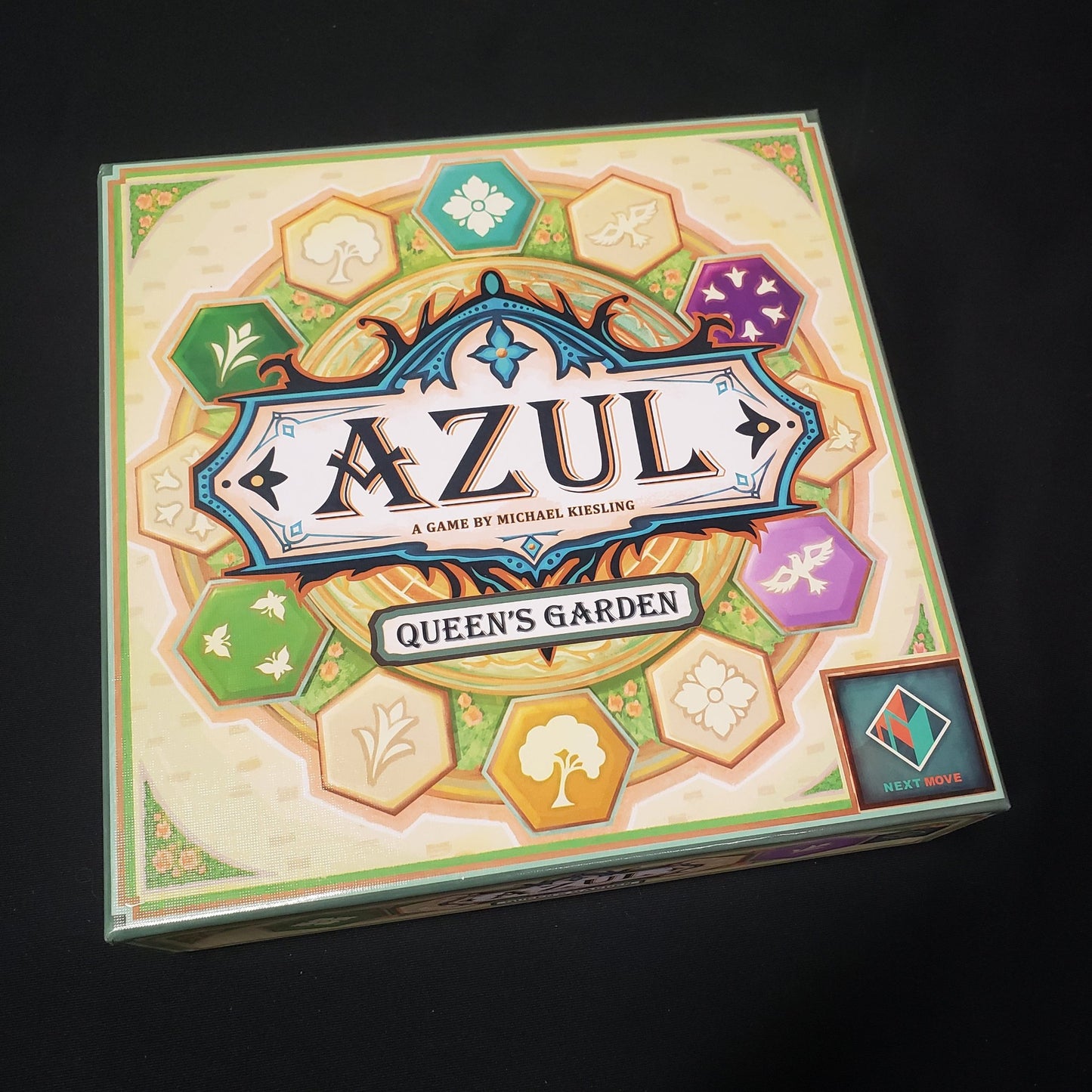 Image shows the front cover of the box of the Azul: Queen's Garden board game