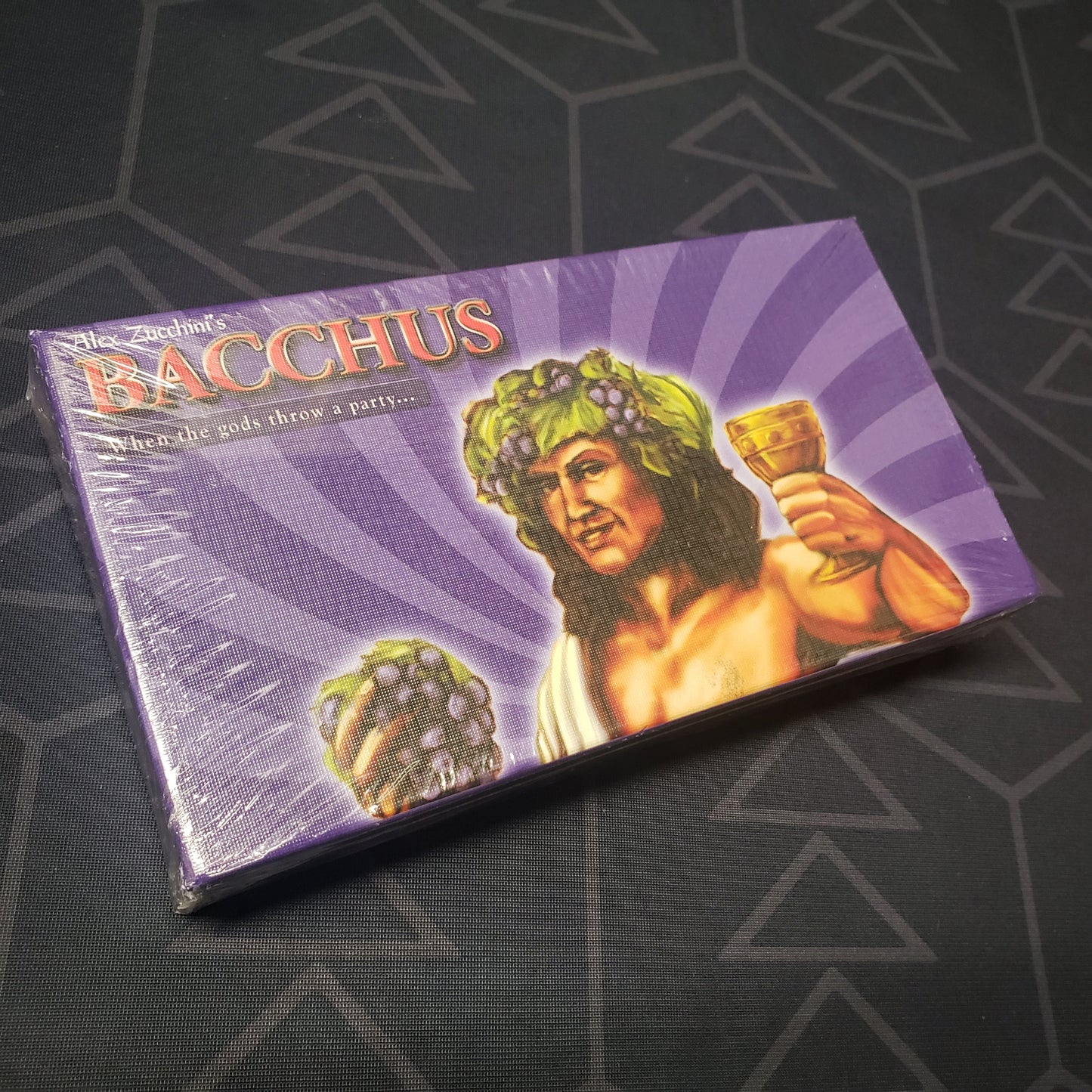 Image shows the front cover of the box for the Bacchus card game