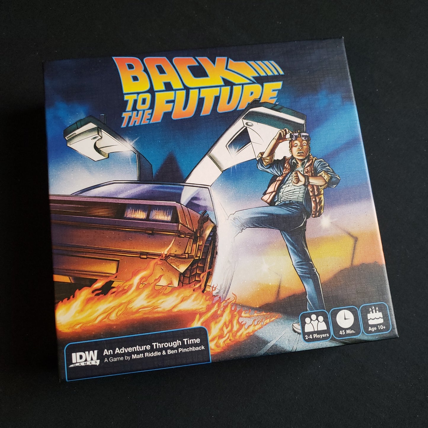 Image shows the front cover of the box of the Back to the Future: An Adventure Through Time board game