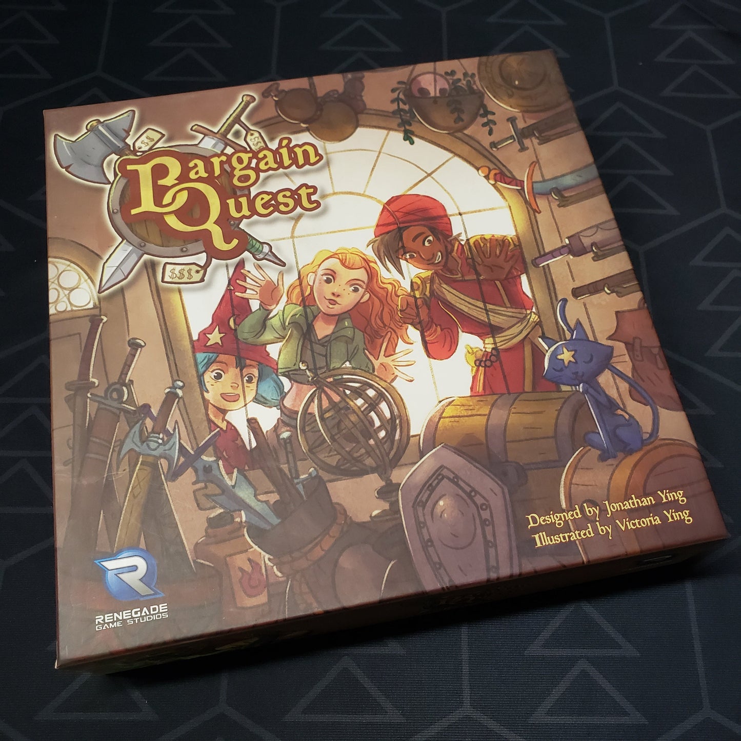 Image shows the front cover of the box of the Bargain Quest board game