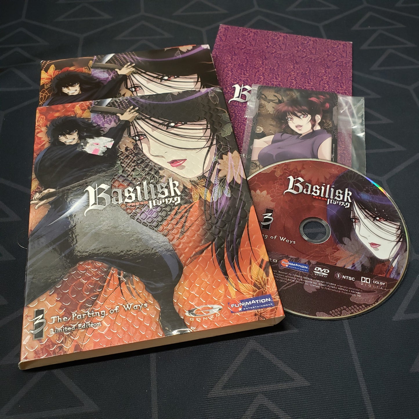 Image shows the case, insert, slipcover, collector card & disc for the limited edition of the Volume 3: The Parting of Ways episode disc of the anime TV series Basilisk on DVD