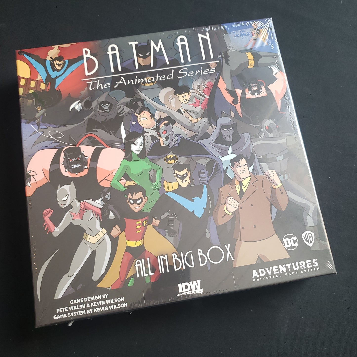 Image shows the front cover of the box of the All In Big Box expansion for the board game Batman: The Animated Series Adventures