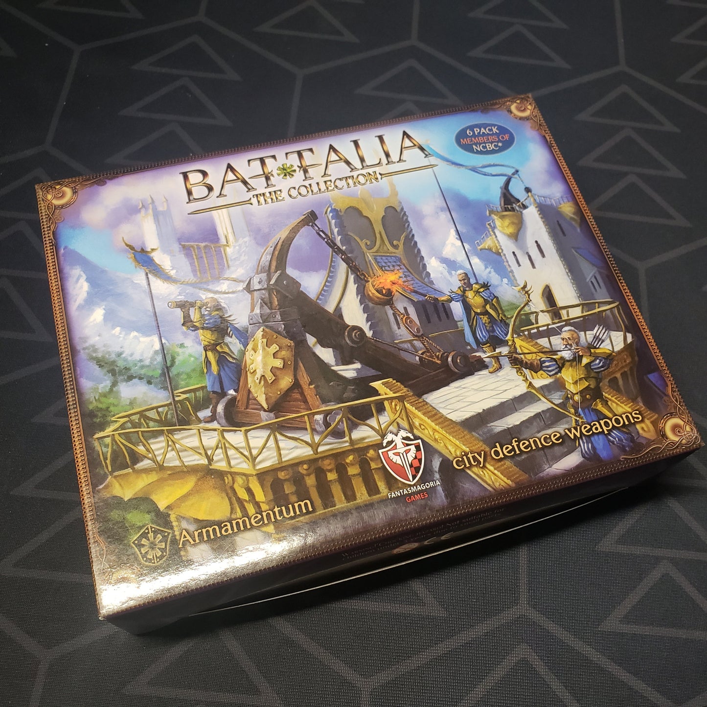 Image shows the front cover of the box of the Armamentum expansion for the board game Battalia