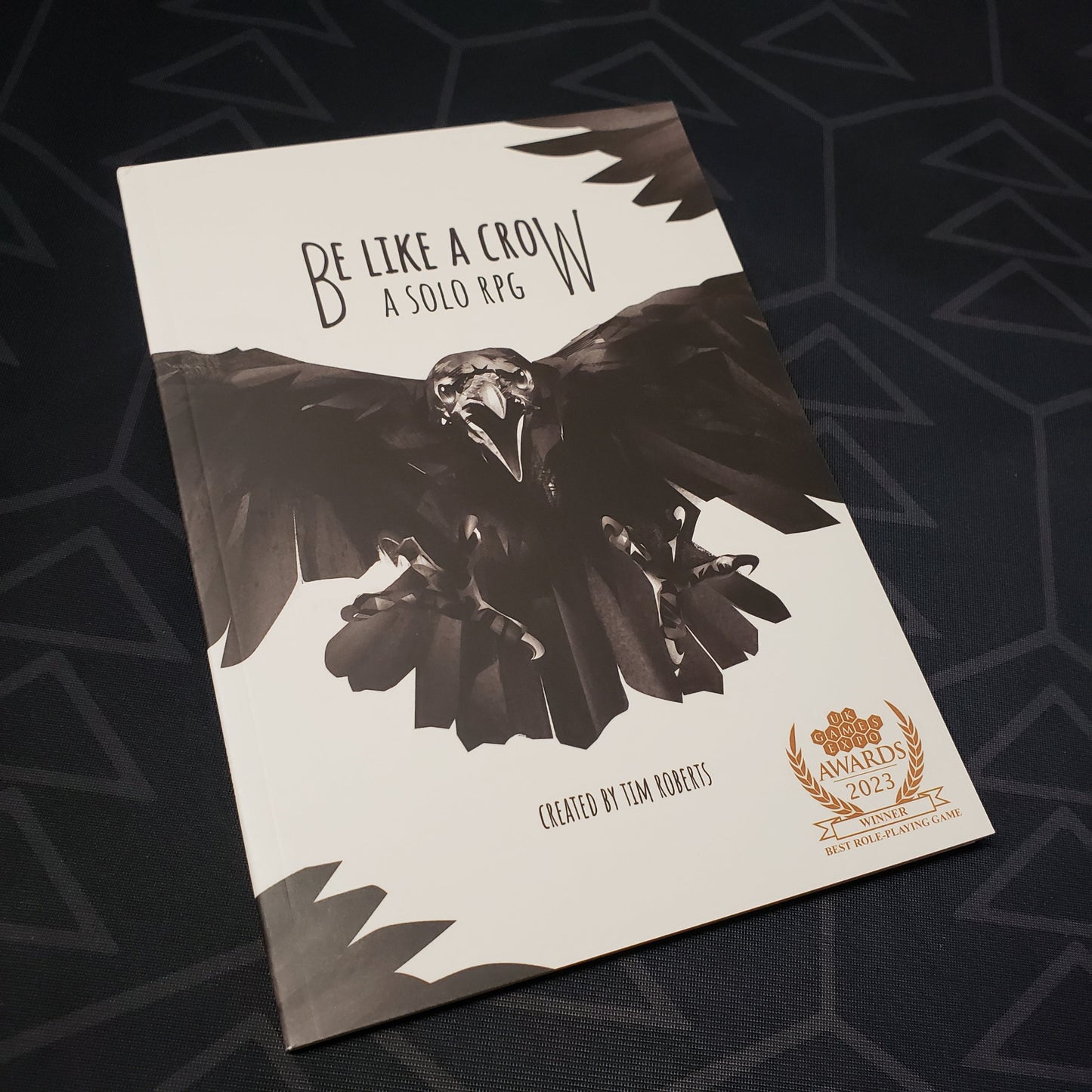 Image shows the front cover of the Be Like a Crow roleplaying game book