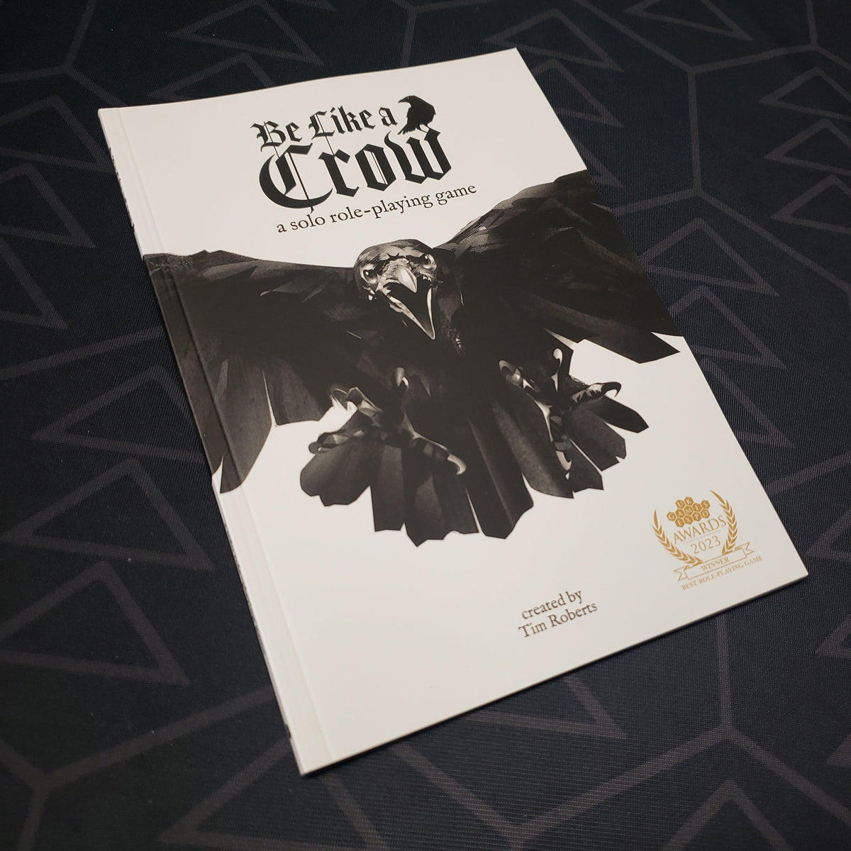 Image shows the front cover of the Be Like a Crow roleplaying game book