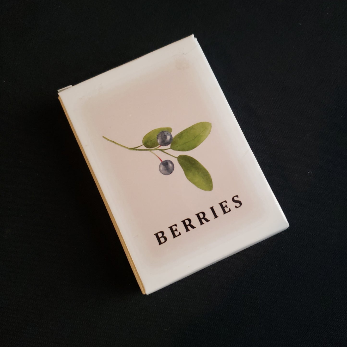 Image shows the front cover of the box of the Berries card game