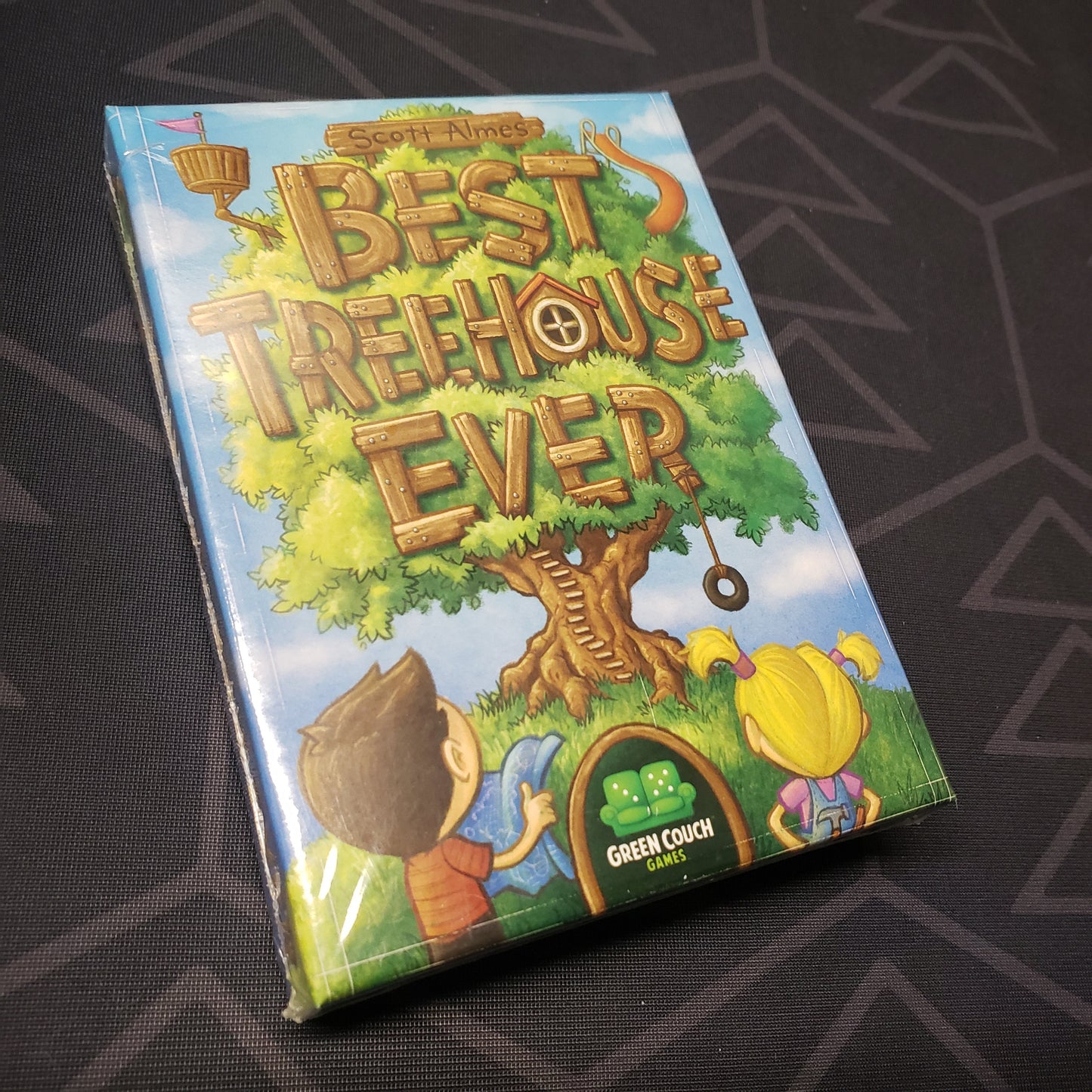 Image shows the front cover of the box of the Best Treehouse Ever card game