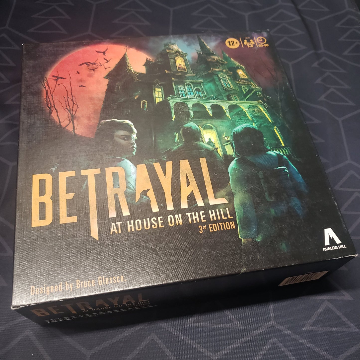 Image shows the front cover of the box for the board game Betrayal at House on the Hill (Third Edition)