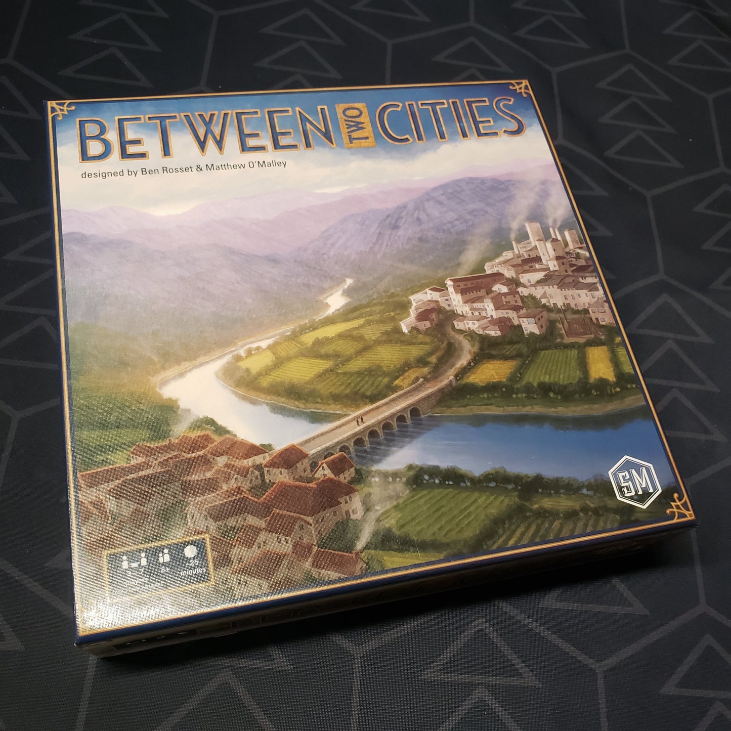 Image shows the front cover of the box of the Between Two Cities board game